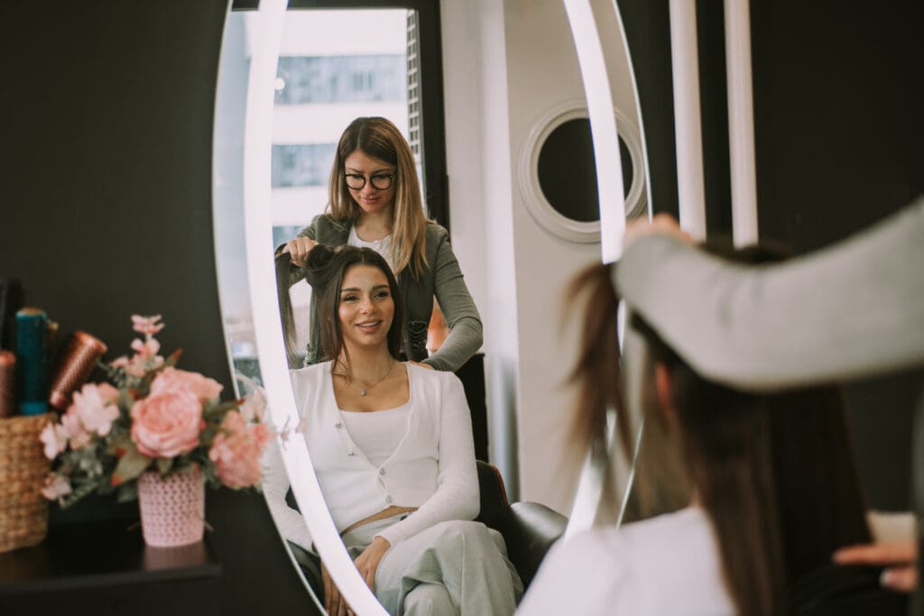 Beauty professionals collaborating on a salon marketing strategy aimed at clientele building, guided by a North Star vision for long-term growth.