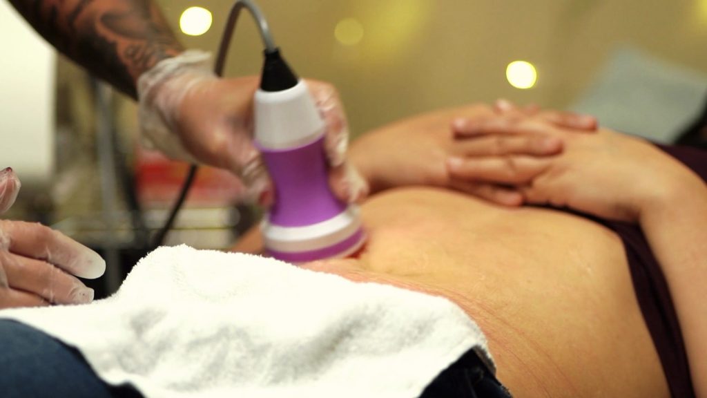 Med spa tech performing a body contouring treatment in her own San Antonio salon suite